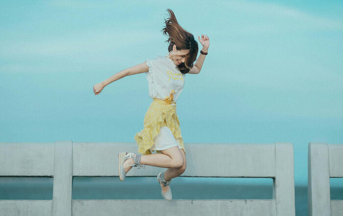 Woman jumping on a bench; Prioritize fun instead of self care