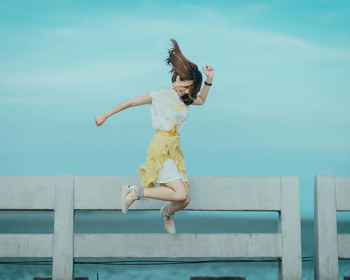 Woman jumping on a bench; Prioritize fun instead of self care