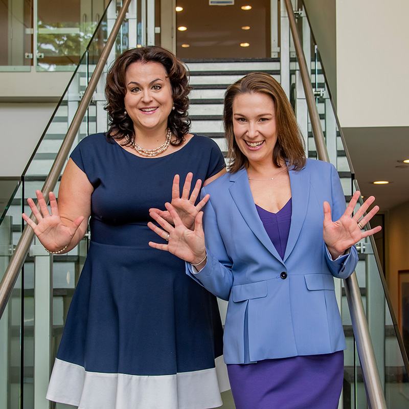 Jenn and Jess waving hands to celebrate new psychology book for children