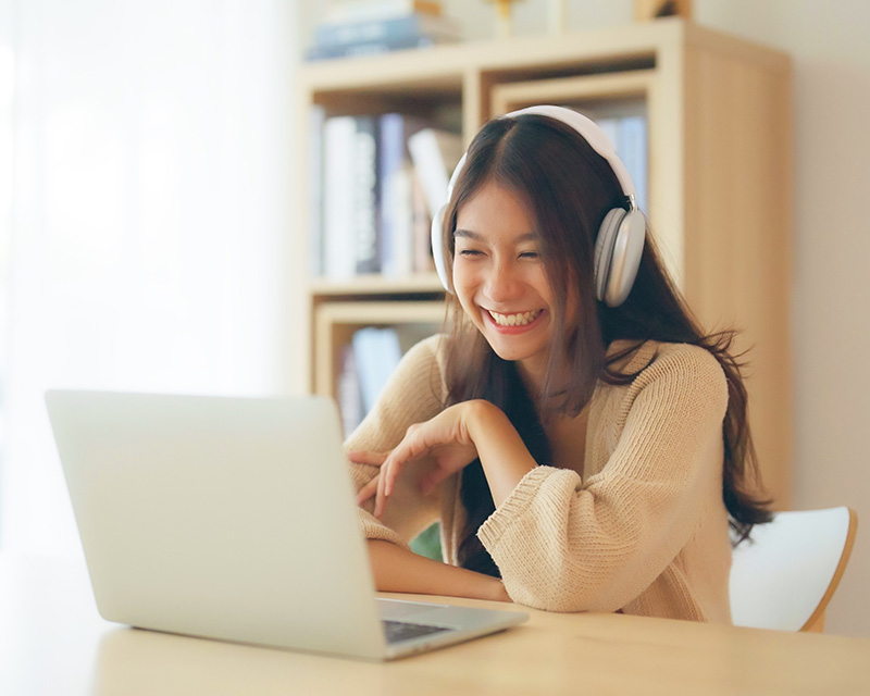 psychotherapy_faq Asian Woman with headphones having an online therapy session